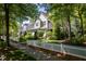 Beautiful home with stone accents, manicured landscaping, and a classic white picket fence at 4210 Falls River Ave, Raleigh, NC 27614