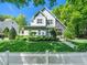 Charming home with a manicured lawn and a white picket fence at 4210 Falls River Ave, Raleigh, NC 27614