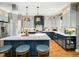 Modern kitchen with a large island, quartz countertops, and stylish pendant lights at 4210 Falls River Ave, Raleigh, NC 27614