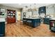 Spacious kitchen with large island, modern stainless appliances, and stylish blue and grey cabinetry at 4210 Falls River Ave, Raleigh, NC 27614