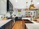 Stylish kitchen with quartz counters, custom cabinets, stainless appliances, and hardwood floors at 4210 Falls River Ave, Raleigh, NC 27614