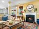 Cozy living room with fireplace, hardwood floors, and bright natural light from the window at 4210 Falls River Ave, Raleigh, NC 27614