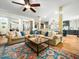 Open-concept living room flowing into the kitchen, featuring hardwood floors and ample seating at 4210 Falls River Ave, Raleigh, NC 27614