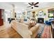 Comfortable living room with hardwood floors, a fireplace, and easy access to the kitchen at 4210 Falls River Ave, Raleigh, NC 27614