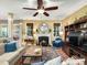 Bright living room featuring a fireplace, hardwood floors, and large windows at 4210 Falls River Ave, Raleigh, NC 27614