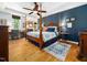 Spacious main bedroom features a four-poster bed, hardwood floors, and a view to the sitting room at 4210 Falls River Ave, Raleigh, NC 27614