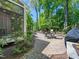 Inviting outdoor patio with dining sets, surrounded by lush greenery and beautiful landscaping at 4210 Falls River Ave, Raleigh, NC 27614