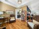 Sitting room with hardwood floors and wicker chairs, connecting to the main bedroom and bathroom at 4210 Falls River Ave, Raleigh, NC 27614