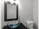 Modern bathroom features a sleek vessel sink, black framed mirror and toilet at 4318 Hunters Club Dr, Raleigh, NC 27606