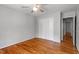 Bedroom featuring hardwood floors, ceiling fan, and closet with double doors at 4318 Hunters Club Dr, Raleigh, NC 27606