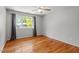 Bedroom with hardwood floors, ceiling fan, and natural light from a window at 4318 Hunters Club Dr, Raleigh, NC 27606