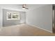 Bright bedroom with neutral walls, tile flooring, and a view to the outside at 4318 Hunters Club Dr, Raleigh, NC 27606