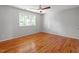 Bedroom with hardwood floors, ceiling fan, and natural light from a window at 4318 Hunters Club Dr, Raleigh, NC 27606