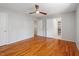 Bedroom boasts hardwood floors, ceiling fan, and access to a closet at 4318 Hunters Club Dr, Raleigh, NC 27606