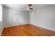 This bedroom has hardwood floors, natural light and a modern ceiling fan at 4318 Hunters Club Dr, Raleigh, NC 27606