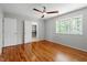 Bedroom with hardwood floors, ceiling fan, and large closet at 4318 Hunters Club Dr, Raleigh, NC 27606