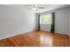 Bedroom featuring hardwood floors, a ceiling fan, and a window with natural lighting at 4318 Hunters Club Dr, Raleigh, NC 27606