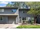 Charming townhome features a gray exterior, attached garage, and mature landscaping at 4318 Hunters Club Dr, Raleigh, NC 27606