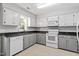 Charming kitchen features white cabinets, modern appliances, and granite countertops at 4318 Hunters Club Dr, Raleigh, NC 27606