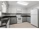 Charming kitchen features white cabinets, modern appliances, and granite countertops at 4318 Hunters Club Dr, Raleigh, NC 27606