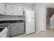 Bright kitchen includes white appliances and plentiful cabinet storage at 4318 Hunters Club Dr, Raleigh, NC 27606
