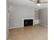 Bright living room with fireplace, built-in shelving, and tile flooring at 4318 Hunters Club Dr, Raleigh, NC 27606