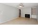 Bright living room with fireplace, built-in shelving, and tile flooring at 4318 Hunters Club Dr, Raleigh, NC 27606