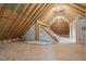 View of unfinished attic area showing wood frame construction and insulation material in place at 45 Leisure Ln # 4, Louisburg, NC 27549