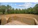 Wood deck features black metal railings and provides an open, unobstructed view of backyard at 45 Leisure Ln # 4, Louisburg, NC 27549