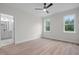 Bright bedroom features light flooring, ceiling fan, and natural lighting from two windows at 45 Leisure Ln # 4, Louisburg, NC 27549