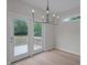 Dining area with double doors leading to back porch and modern chandelier at 45 Leisure Ln # 4, Louisburg, NC 27549