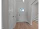 Bright entryway with light wood flooring, a white front door with glass, and coat closet at 45 Leisure Ln # 4, Louisburg, NC 27549