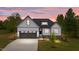 Charming new construction home featuring a two-car garage, stone accents and lush landscaping at 45 Leisure Ln # 4, Louisburg, NC 27549