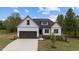 Charming new construction home featuring a two-car garage, stone accents and lush landscaping at 45 Leisure Ln # 4, Louisburg, NC 27549