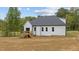 Exterior view of the white home showing the backyard deck, dark roof, and siding at 45 Leisure Ln # 4, Louisburg, NC 27549