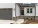 Exterior of home has stone accents, gray garage door and front door, and manicured landscaping at 45 Leisure Ln # 4, Louisburg, NC 27549