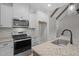 Bright kitchen features stainless appliances, granite counters, backsplash, and white cabinets at 45 Leisure Ln # 4, Louisburg, NC 27549