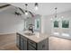 Open concept kitchen features granite counters, an island with sink, and natural lighting at 45 Leisure Ln # 4, Louisburg, NC 27549