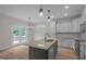 Bright kitchen features stainless appliances, light cabinets, granite counters, and backyard access at 45 Leisure Ln # 4, Louisburg, NC 27549