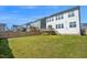 Grassy backyard showing the home with a deck, stairs to the yard, and a wood fence dividing the properties at 4816 Heathshire Dr, Raleigh, NC 27616