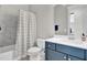 Well-lit bathroom with modern vanity, marble-tile surround, and a shower/tub combo at 4816 Heathshire Dr, Raleigh, NC 27616