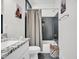 Stylish bathroom features a vanity with granite countertops, tub/shower and modern gray tile at 4816 Heathshire Dr, Raleigh, NC 27616
