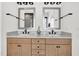 Bathroom vanity featuring double sinks, light wood cabinetry, and stylish fixtures at 4816 Heathshire Dr, Raleigh, NC 27616