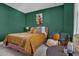 Stylish bedroom boasts a bed with gold bedding, a plush chair and a unique decor at 4816 Heathshire Dr, Raleigh, NC 27616