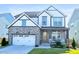 Charming two-story home with stone accents, a two-car garage, a cozy porch, and lovely curb appeal at 4816 Heathshire Dr, Raleigh, NC 27616