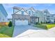 Charming two-story home with stone accents, a two-car garage, and a well-manicured lawn at 4816 Heathshire Dr, Raleigh, NC 27616