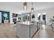 Bright, open kitchen with an island and marble countertops overlooking the living area at 4816 Heathshire Dr, Raleigh, NC 27616