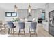 Bright kitchen featuring a center island with seating, stainless steel appliances, and modern fixtures at 4816 Heathshire Dr, Raleigh, NC 27616
