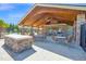 Covered outdoor patio with stone fireplace and ceiling fan, perfect for entertaining guests by the pool at 4816 Heathshire Dr, Raleigh, NC 27616