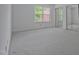 Bright bedroom featuring neutral carpeting, two windows, and a mirrored closet at 497 Summerwalk Cir # 497, Chapel Hill, NC 27517